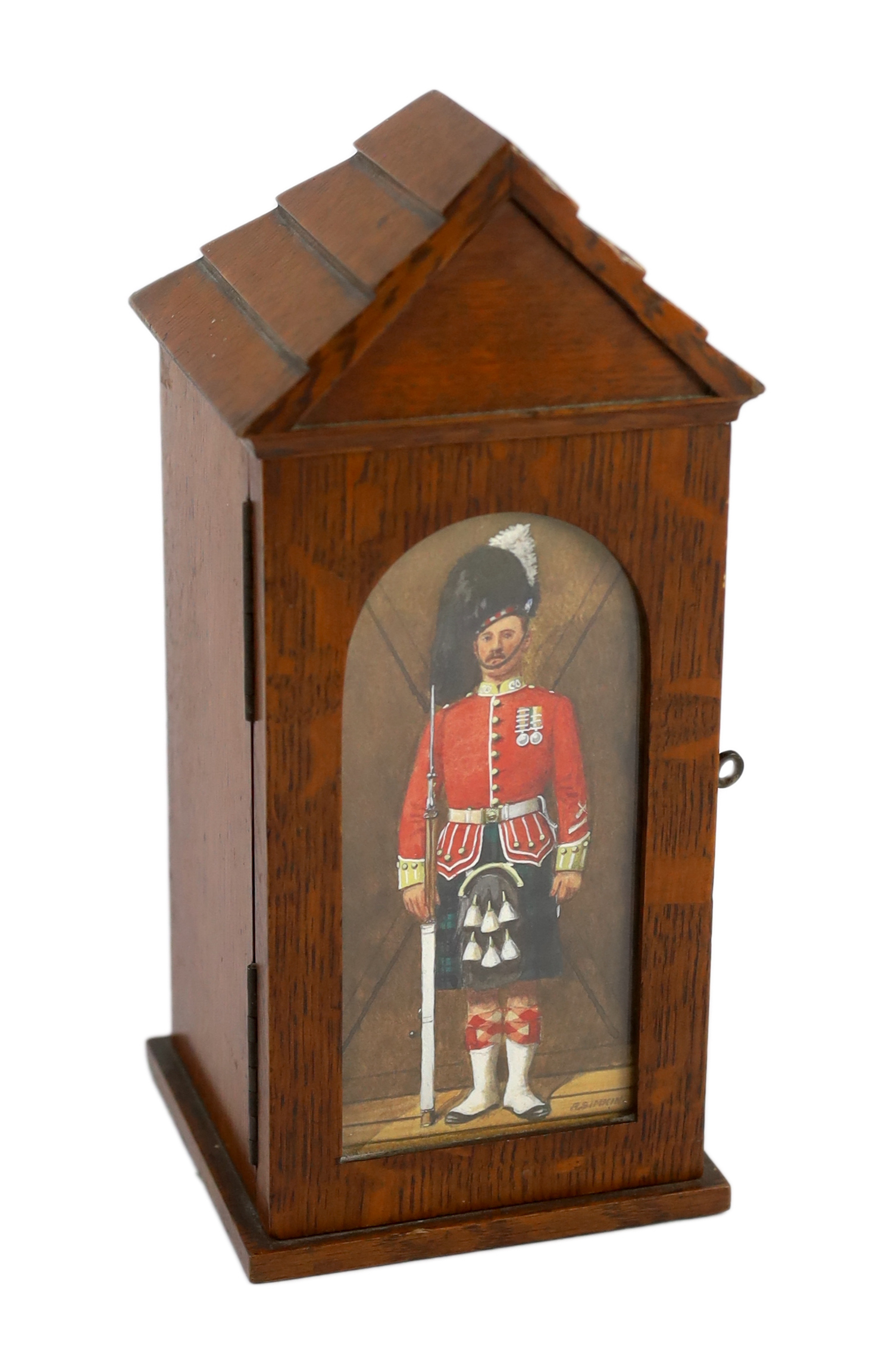 A late Victorian oak smoker’s cabinet modelled as a sentry box with a watercolour panel by Richard Simkin (1840-1926)